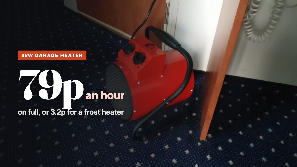 A red industrial electric fan heater standing on a carpeted floor
